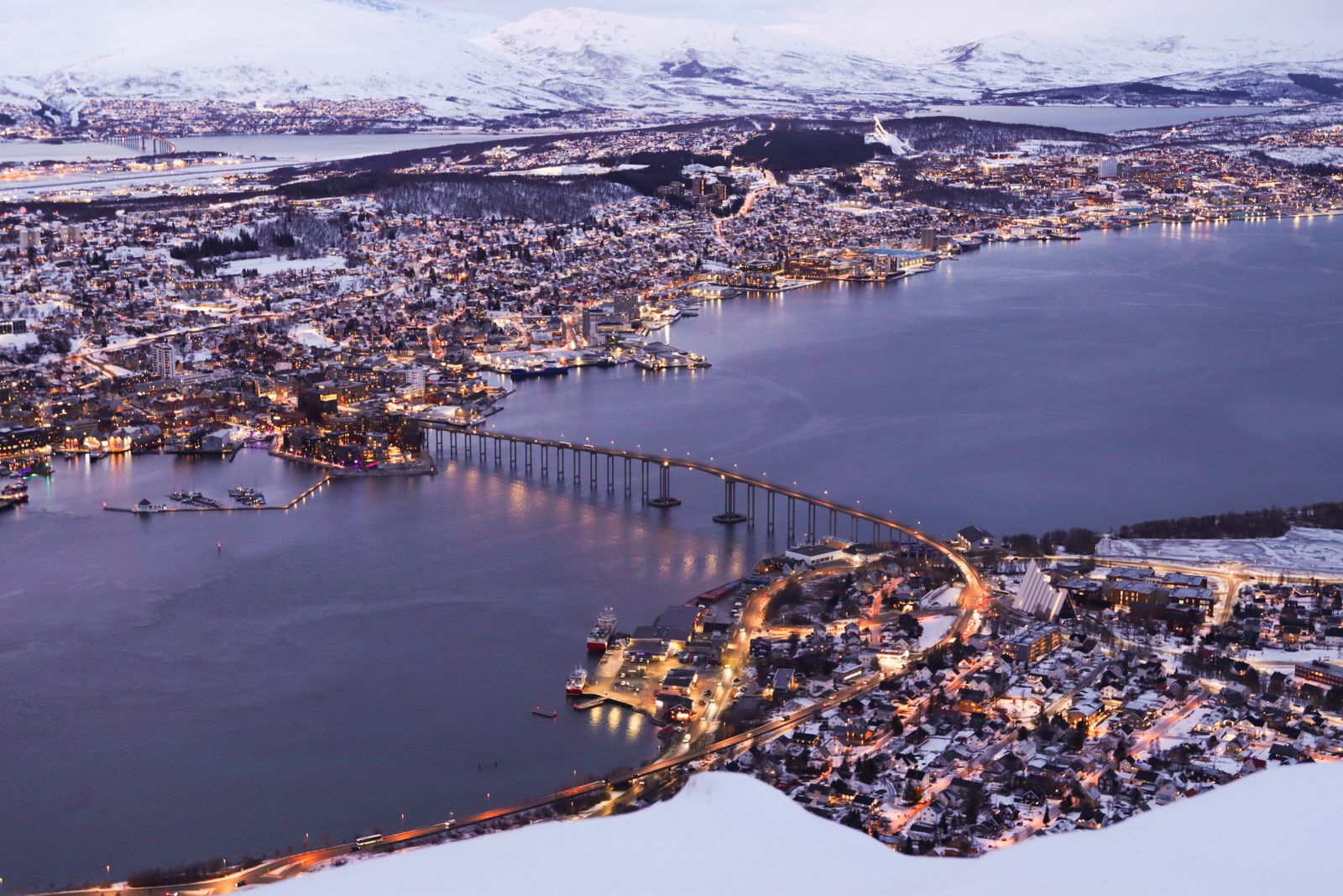Aerial view of Tromsø and its bridge at winter twilight