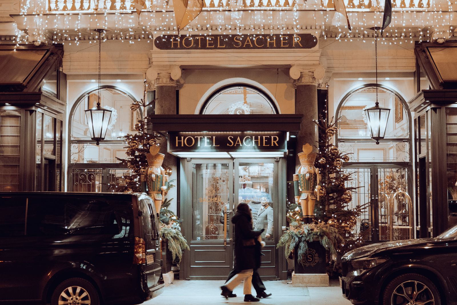 The entrance of Hotel Sacher in Vienna at night, decorated for Christmas