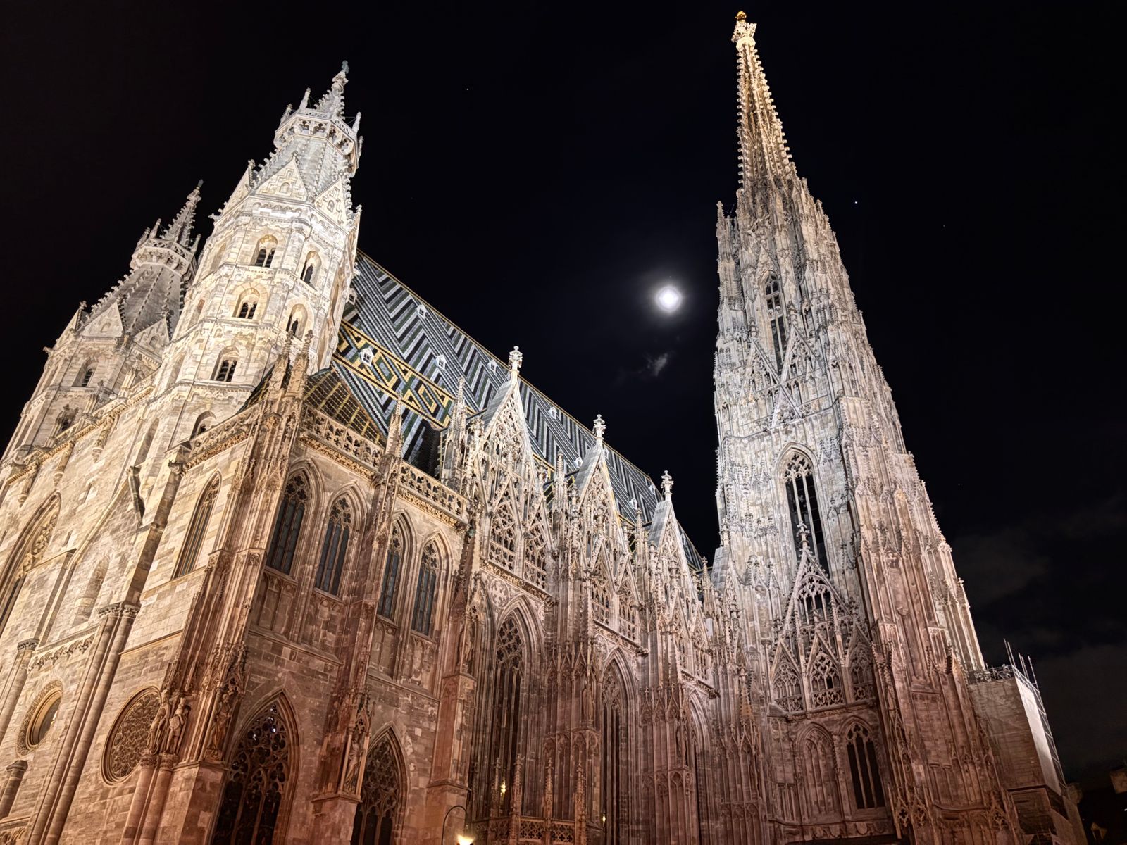 The Gothic spire of St. Stephen's Cathedral in Vienna lit at night