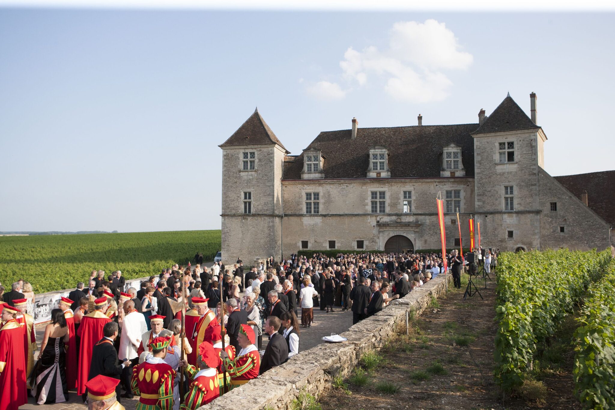 Guests arriving at the Ch&acirc;teau du Clos de Vougeot, with members in crimson and gold in the foreground