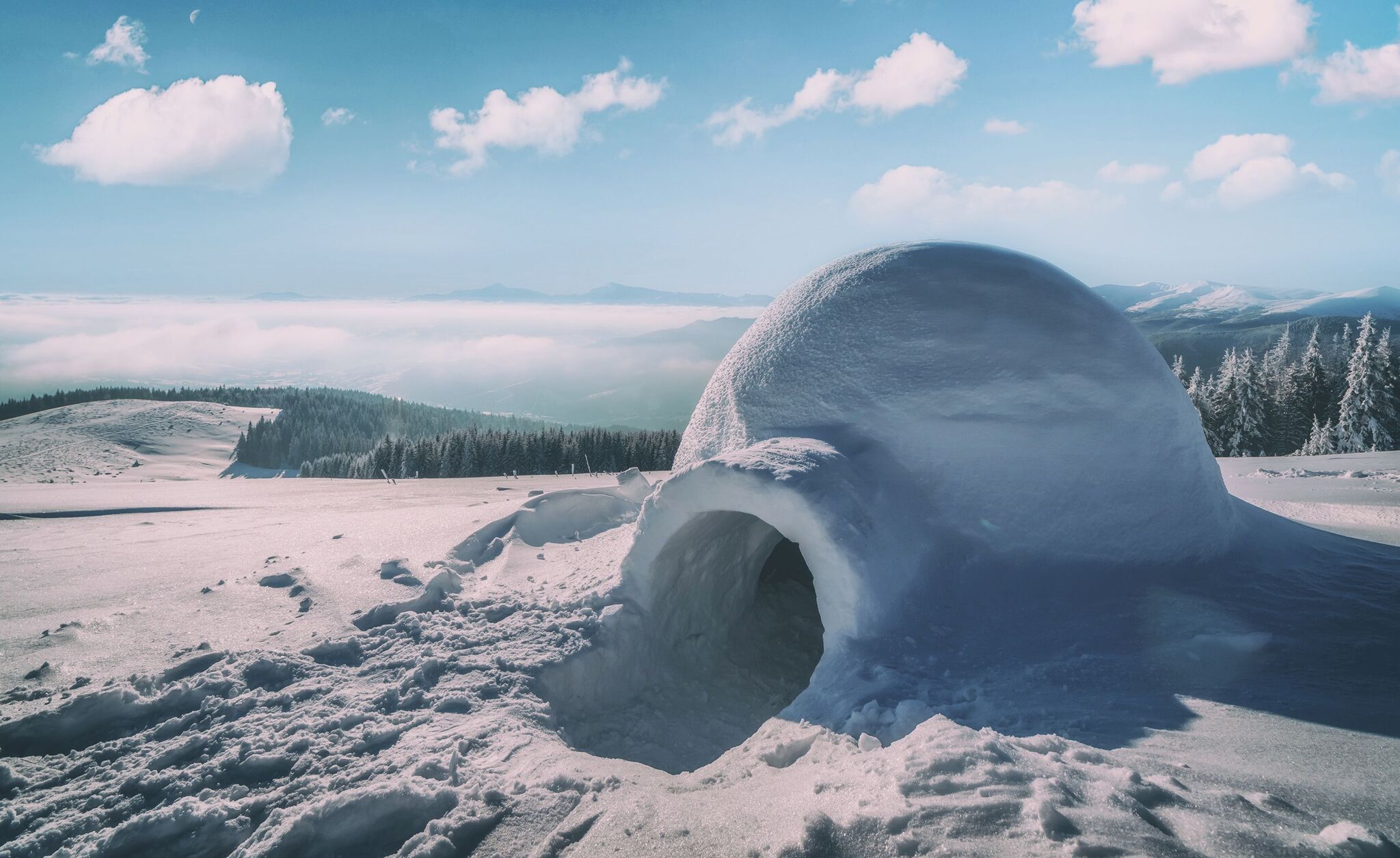 A private snow igloo on a mountain ridge above the clouds