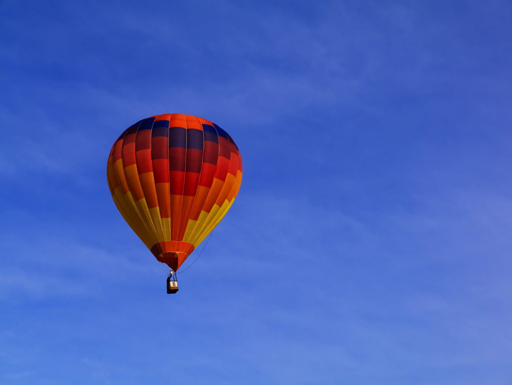 A hot-air balloon at sunrise over the valley