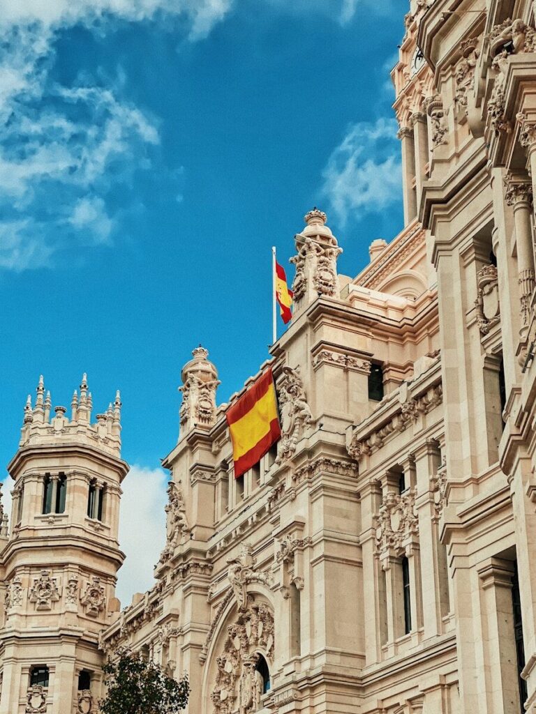 Tenerife to Ribera del Duero: A Private Wine Journey 6 yellow and red flag hanging on white building